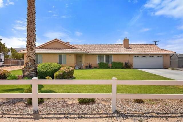single story home featuring a front lawn, a tiled roof, fence, a garage, and stucco siding