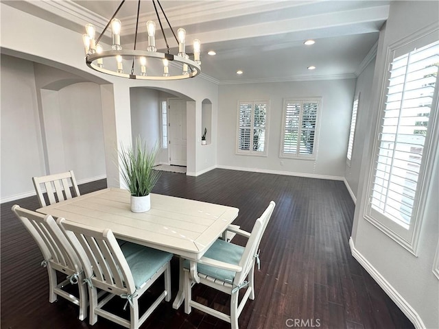 dining area with crown molding, baseboards, a notable chandelier, and a wealth of natural light
