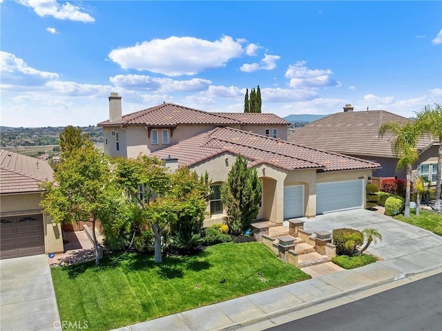 mediterranean / spanish home with driveway, a tile roof, a front lawn, an attached garage, and stucco siding