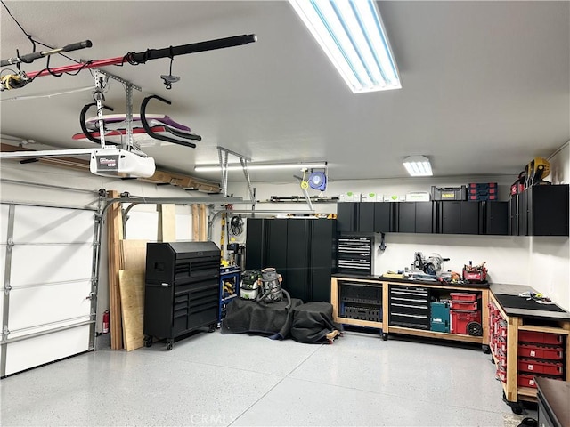 garage featuring a workshop area and a garage door opener