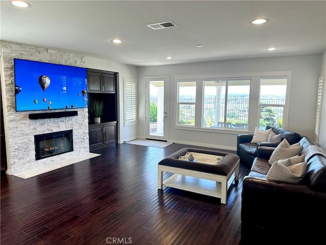 living room with baseboards, visible vents, and dark wood-type flooring