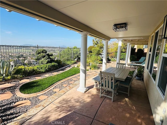 view of patio featuring fence and outdoor dining space