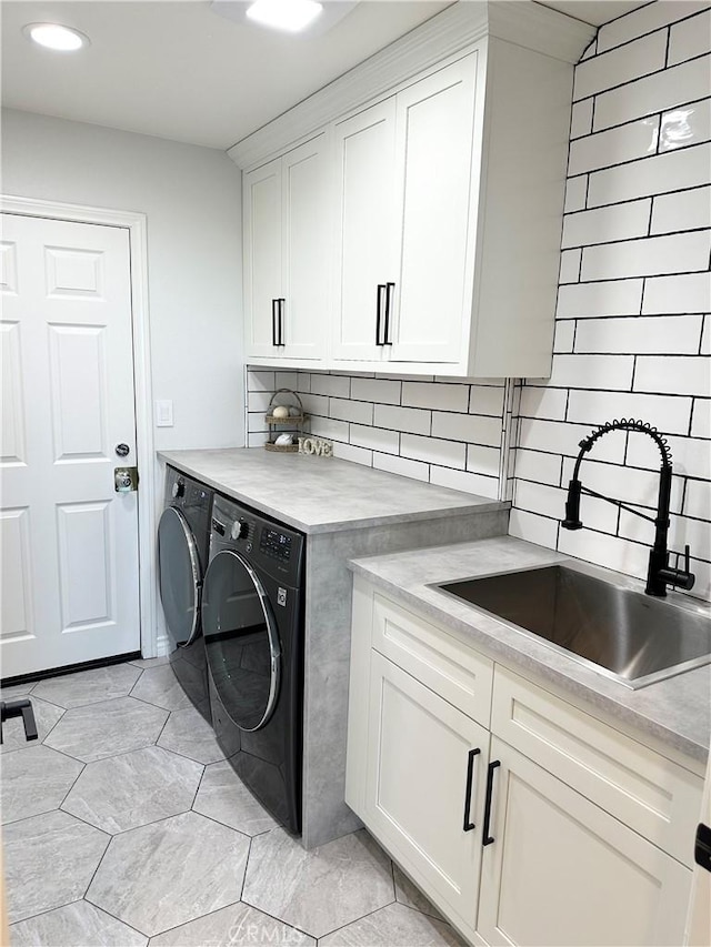clothes washing area featuring cabinet space, a sink, recessed lighting, light tile patterned flooring, and washer and clothes dryer