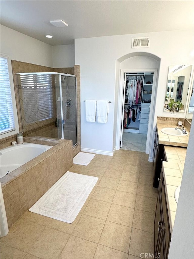 full bath featuring vanity, tile patterned floors, visible vents, a bath, and a stall shower