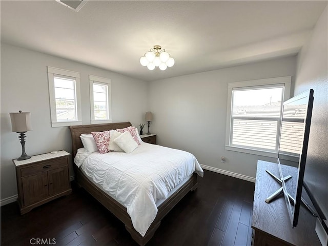 bedroom with baseboards, dark wood-style floors, and visible vents