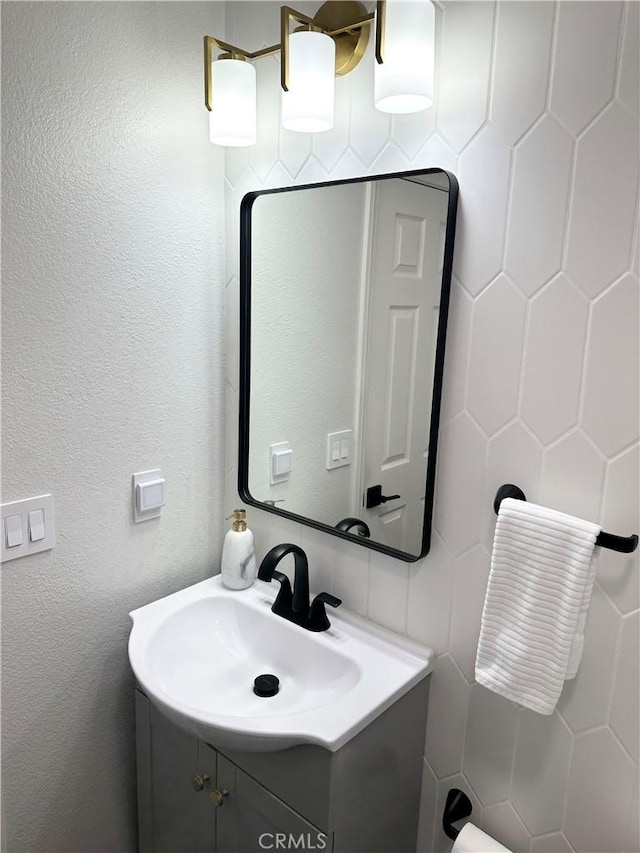 bathroom with tile walls and vanity