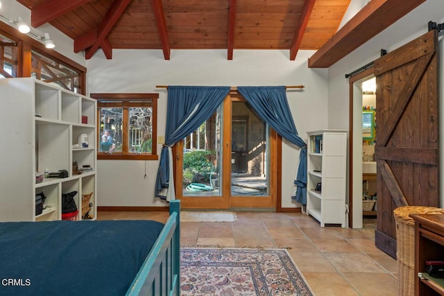 bedroom with a barn door, stone tile floors, access to exterior, baseboards, and wood ceiling