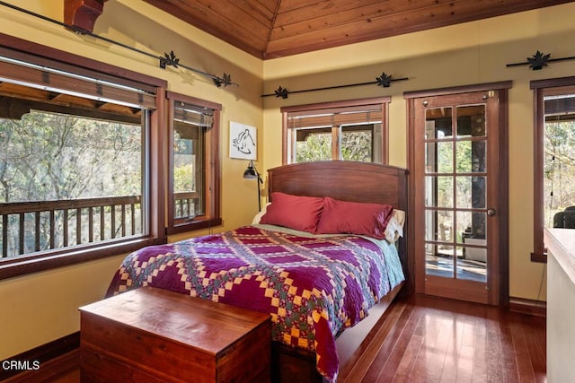 bedroom with baseboards, access to exterior, and wood-type flooring
