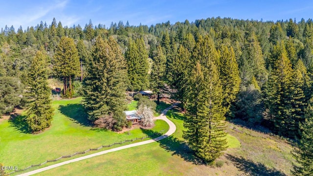 drone / aerial view featuring a view of trees