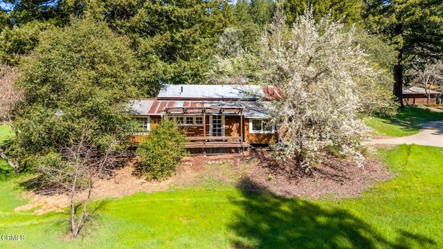 back of house with a lawn and a wooden deck
