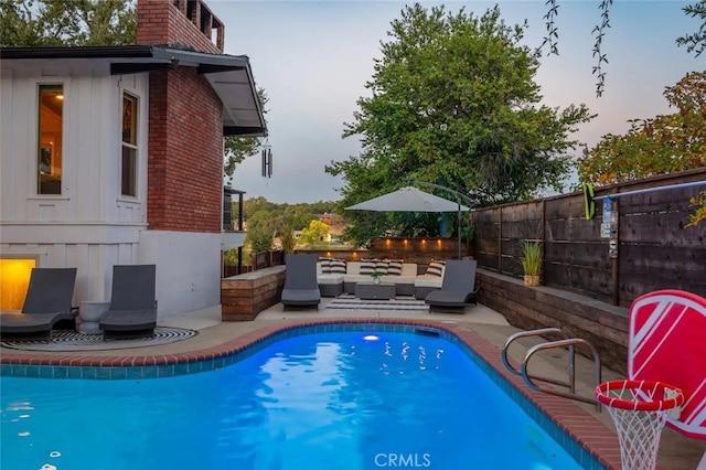 8035 Santa Rosa Rd, Atascadero, CA 93422 - pool at dusk featuring a fenced backyard, an outdoor living space, and a patio