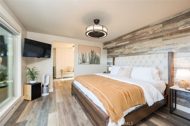 8035 Santa Rosa Rd, Atascadero, CA 93422 - bedroom featuring wood walls, an accent wall, and wood finished floors