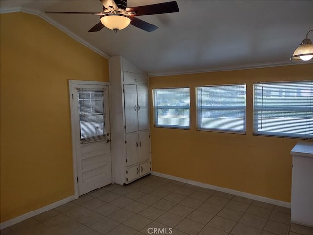 spare room featuring baseboards, a ceiling fan, and crown molding