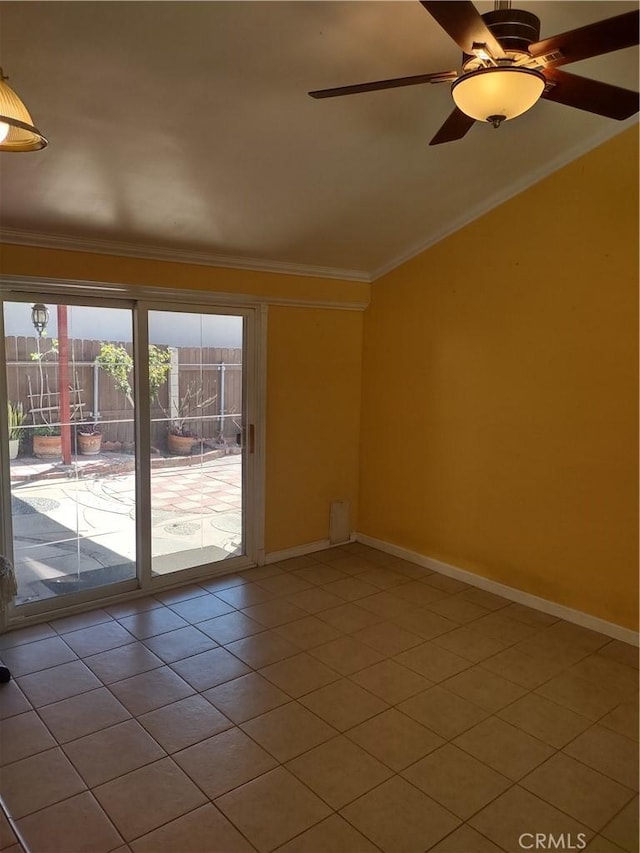 tiled empty room with ceiling fan, vaulted ceiling, baseboards, and ornamental molding