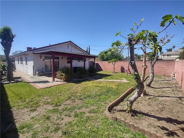 view of yard featuring a patio area and a fenced backyard