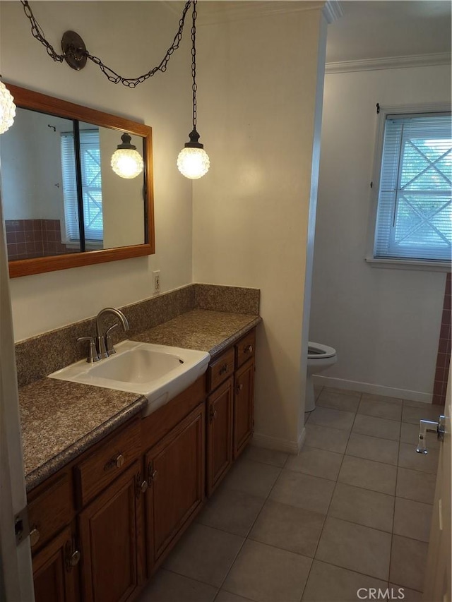 bathroom featuring plenty of natural light, baseboards, tile patterned flooring, and crown molding
