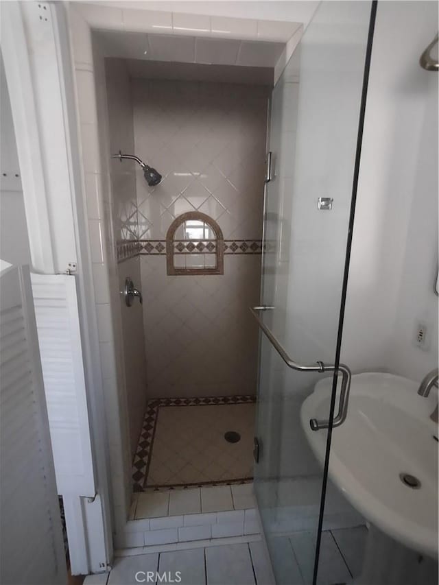 bathroom featuring tile patterned flooring and a stall shower