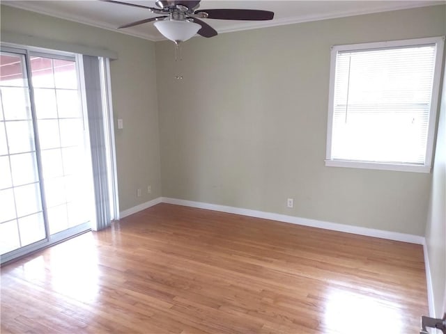 unfurnished room featuring light wood-style floors, plenty of natural light, ceiling fan, and ornamental molding