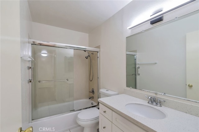 full bath with combined bath / shower with glass door, toilet, and vanity