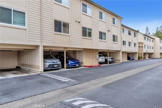 exterior space featuring a residential view and covered parking
