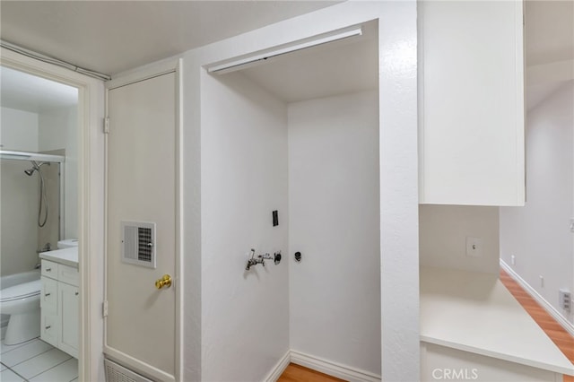 full bathroom featuring a shower with shower door, visible vents, toilet, and vanity