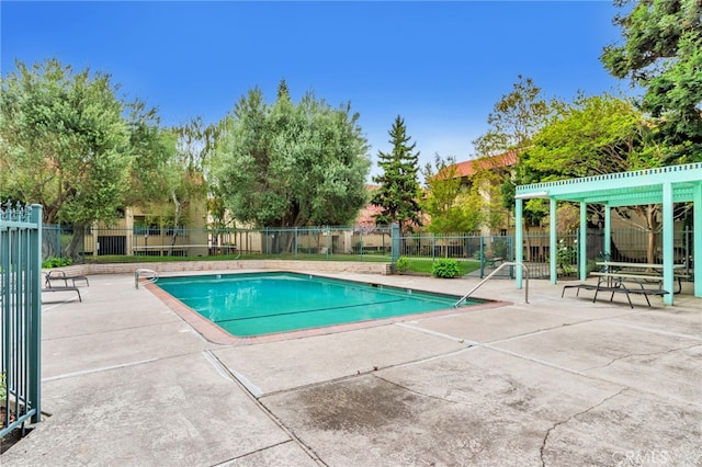 community pool with a patio and fence