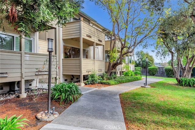 exterior space featuring a lawn and fence