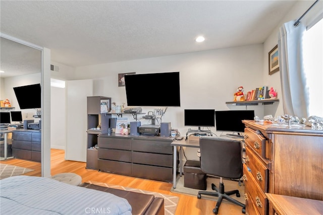 bedroom with recessed lighting, visible vents, and wood finished floors