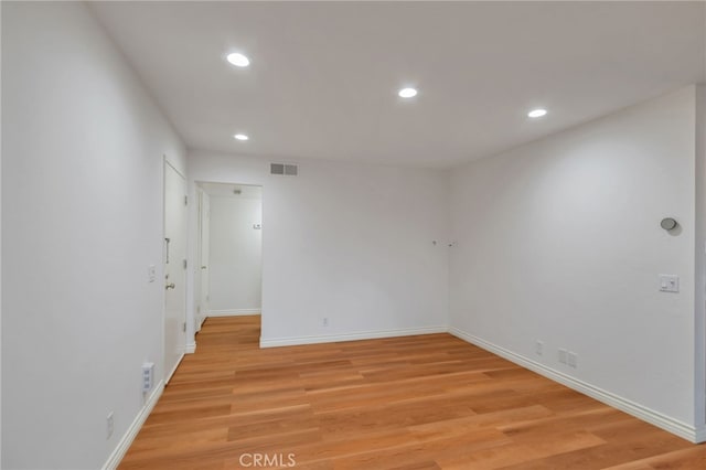 empty room featuring visible vents, recessed lighting, and light wood-style floors