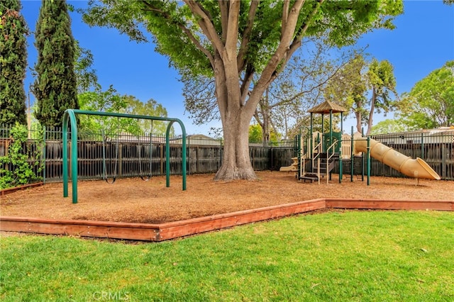 communal playground with a lawn and fence