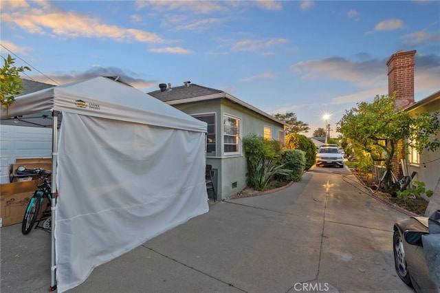 property exterior at dusk with stucco siding