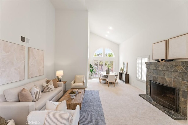10 Cedarlake Unit 4, Irvine, CA 92614 - carpeted living area featuring visible vents, high vaulted ceiling, and a fireplace with raised hearth