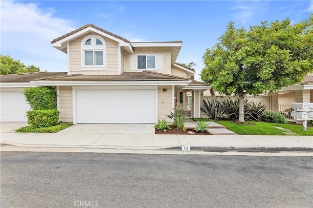 10 Cedarlake Unit 4, Irvine, CA 92614 - traditional-style house with an attached garage, driveway, and a tile roof