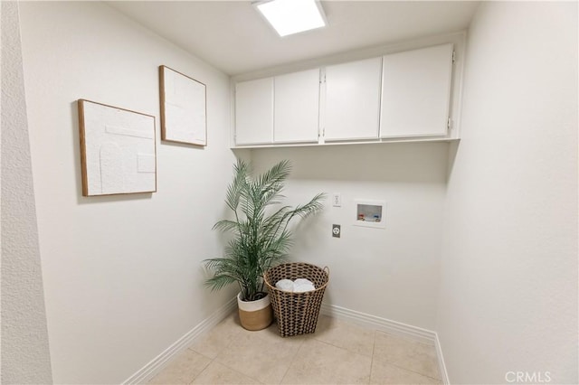10 Cedarlake Unit 4, Irvine, CA 92614 - clothes washing area featuring hookup for an electric dryer, light tile patterned flooring, baseboards, hookup for a washing machine, and cabinet space