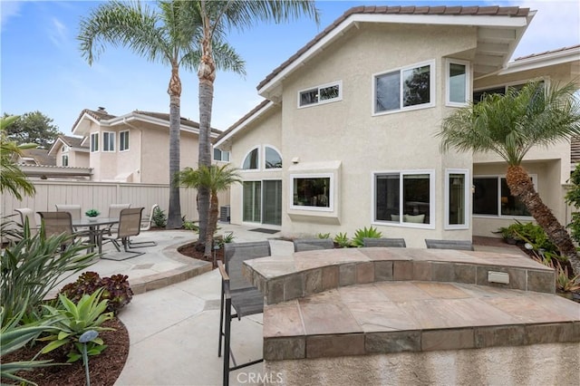 10 Cedarlake Unit 4, Irvine, CA 92614 - back of house with stucco siding, fence, and a patio