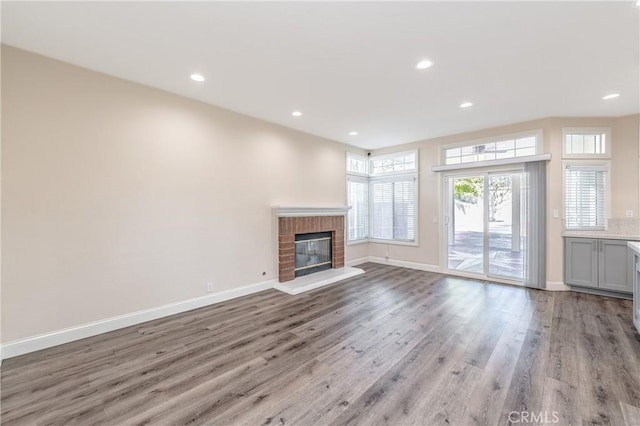 429 Somerset Cir, Corona, CA 92879 - unfurnished living room featuring wood finished floors, baseboards, a brick fireplace, and recessed lighting