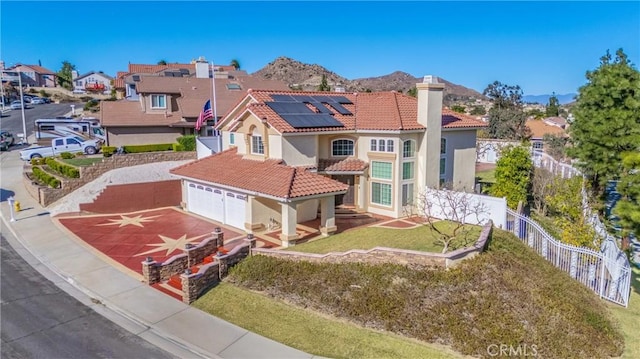 429 Somerset Cir, Corona, CA 92879 - view of front of house with a tile roof, roof mounted solar panels, stucco siding, a chimney, and driveway