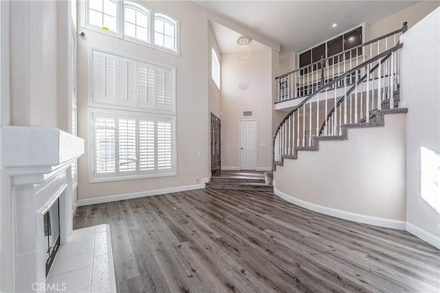429 Somerset Cir, Corona, CA 92879 - entryway featuring a high ceiling, baseboards, wood finished floors, stairs, and a fireplace