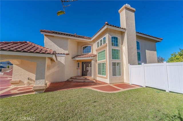 429 Somerset Cir, Corona, CA 92879 - back of house featuring a tiled roof, a chimney, stucco siding, and a patio