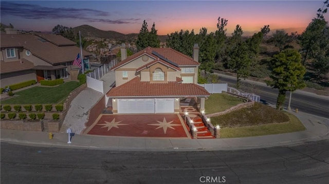 429 Somerset Cir, Corona, CA 92879 - view of front of house featuring a tiled roof, driveway, an attached garage, and stucco siding