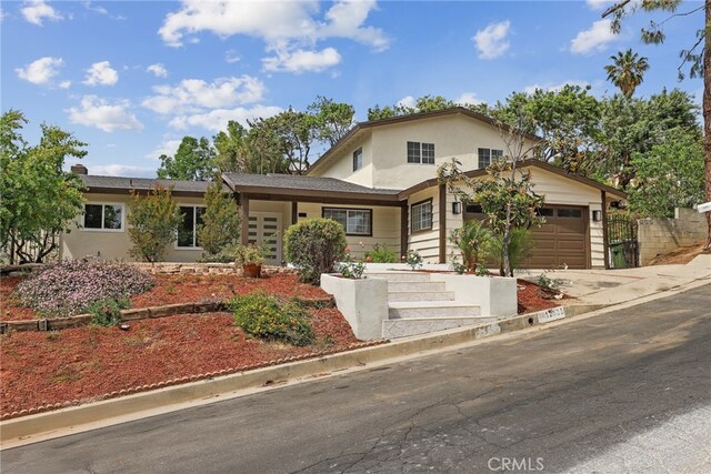 12635 Dorina Pl, Granada Hills, CA 91344 - traditional-style home featuring a garage, concrete driveway, and stucco siding