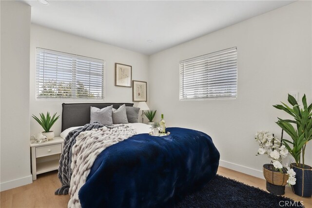 12635 Dorina Pl, Granada Hills, CA 91344 - bedroom with baseboards and wood finished floors