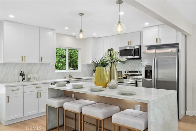 12635 Dorina Pl, Granada Hills, CA 91344 - kitchen featuring stainless steel appliances, a sink, white cabinets, and recessed lighting
