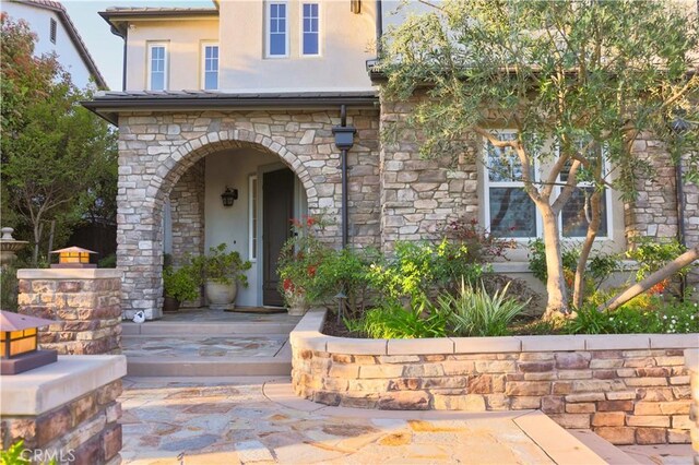 30304 Vercors St, Murrieta, CA 92563 - view of exterior entry featuring stucco siding, stone siding, and a porch