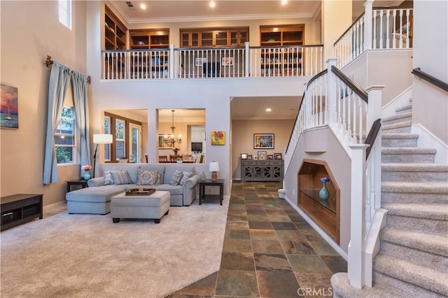 30304 Vercors St, Murrieta, CA 92563 - living room with stairs, a towering ceiling, ornamental molding, dark stone finish flooring, and recessed lighting