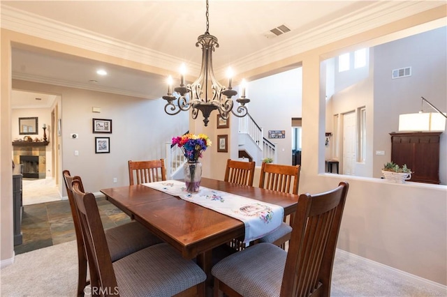 30304 Vercors St, Murrieta, CA 92563 - dining space with a chandelier, stairs, ornamental molding, carpet flooring, and a fireplace
