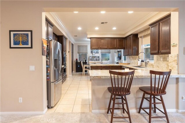 30304 Vercors St, Murrieta, CA 92563 - kitchen with appliances with stainless steel finishes, a sink, a peninsula, crown molding, and decorative backsplash