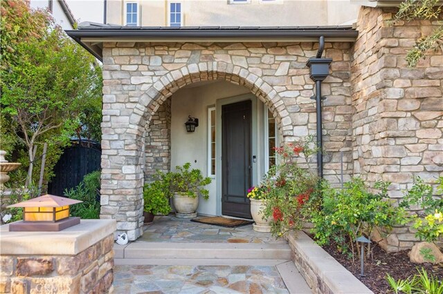 30304 Vercors St, Murrieta, CA 92563 - doorway to property with stone siding, fence, and stucco siding