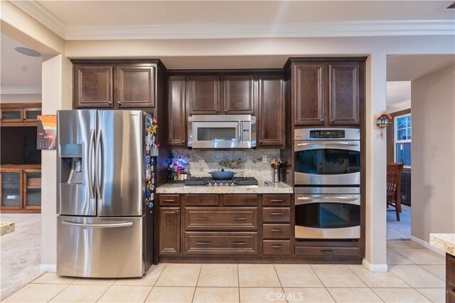 30304 Vercors St, Murrieta, CA 92563 - kitchen featuring stainless steel appliances, light tile patterned floors, dark brown cabinetry, and ornamental molding