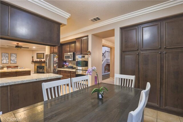 30304 Vercors St, Murrieta, CA 92563 - dining area with light tile patterned floors, a ceiling fan, ornamental molding, and stairway